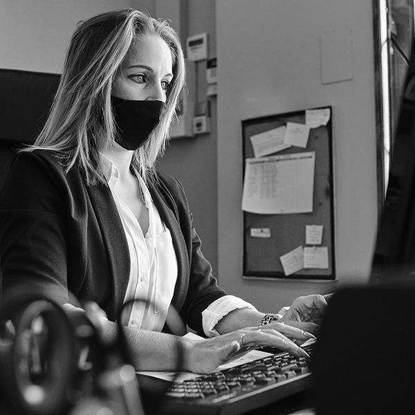 a secretary with protective mask working- new normal